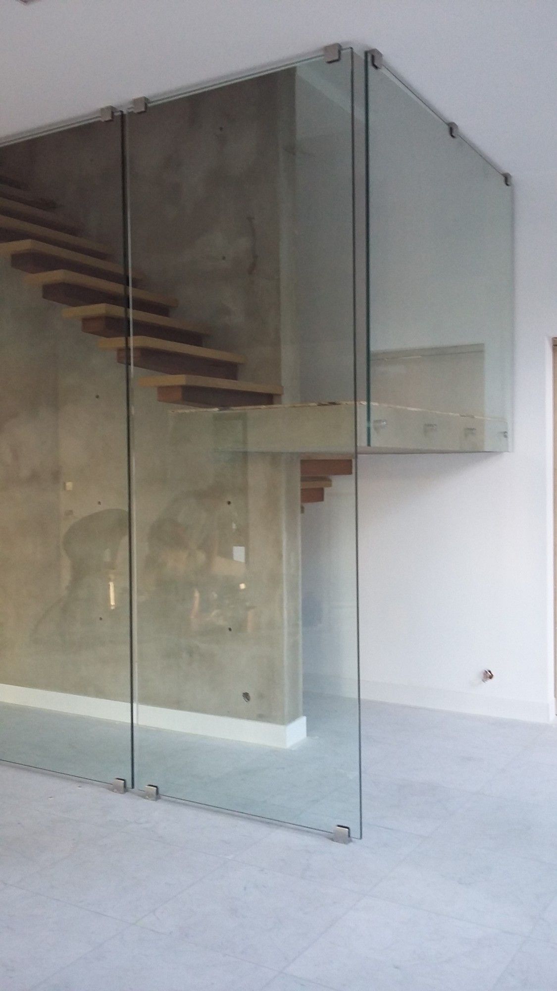 Pose de parois de verre autour d'un escalier dans une villa en contruction à Marseille